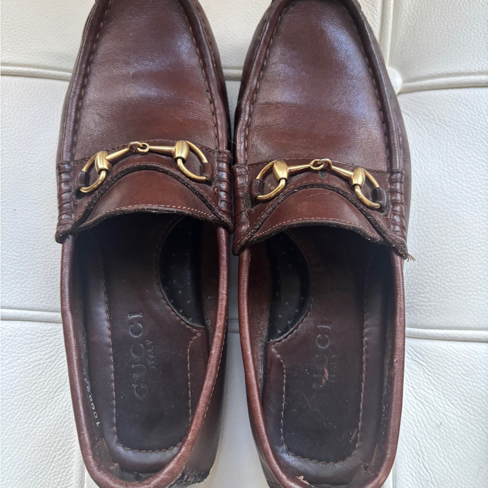 Women’s classic Gucci driving loafer, brown leather, gold horsebit hardware.